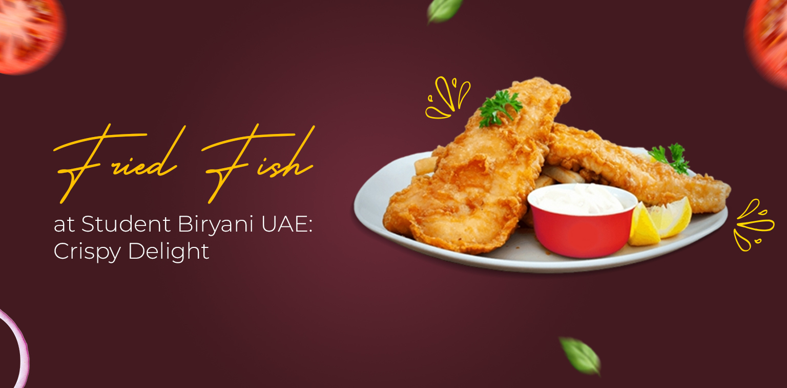 A plate with two pieces of golden fried fish, a lemon wedge, and a small cup of dipping sauce is displayed on a maroon background with text reading “Fried Fish & Seekh Kabab at Student Biryani UAE: Crispy Delight.”.